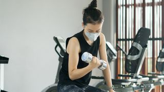 Woman in the gym with a mask