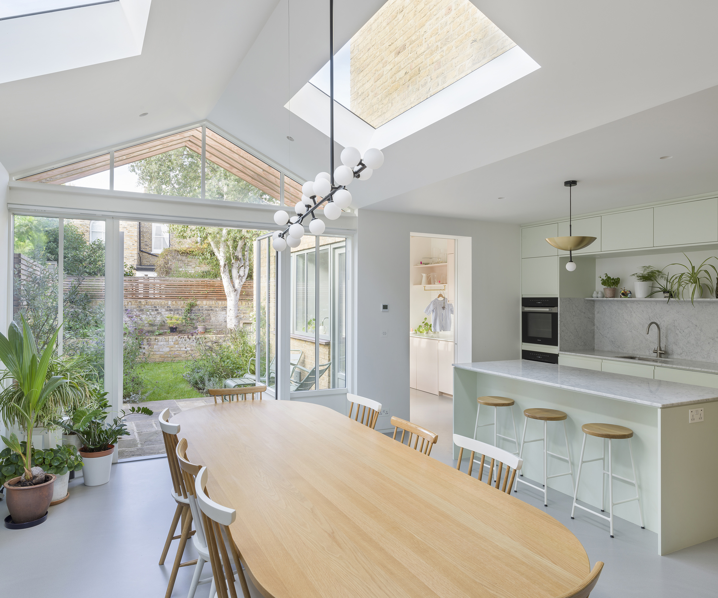 A beautiful rear kitchen extension flooded with natural light from French-style doors and roof glazing.