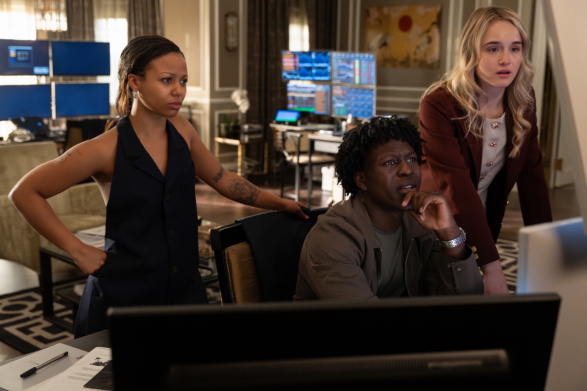 Myha&amp;rsquo;la, Toheeb Jimoh, Miriam Petche as harper Kwabena and sweetpea looking at a computer screen in their office out of a hotel room in industry season 4