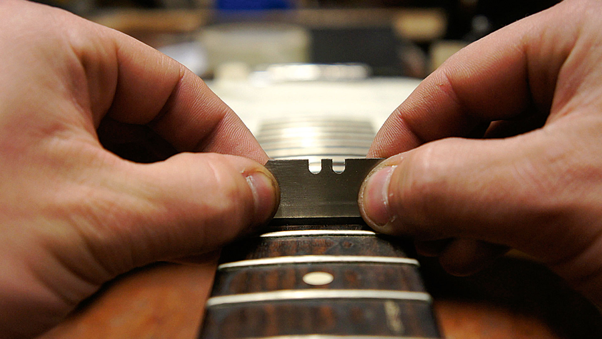 Scraping gunk off a fretboard