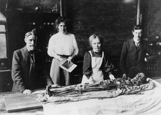 Margaret Murray and her colleagues unwrap the mummy of Nakht-Ankh, which was sent from Egypt to Manchester in 1908.