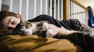 Cat sleeping with boy