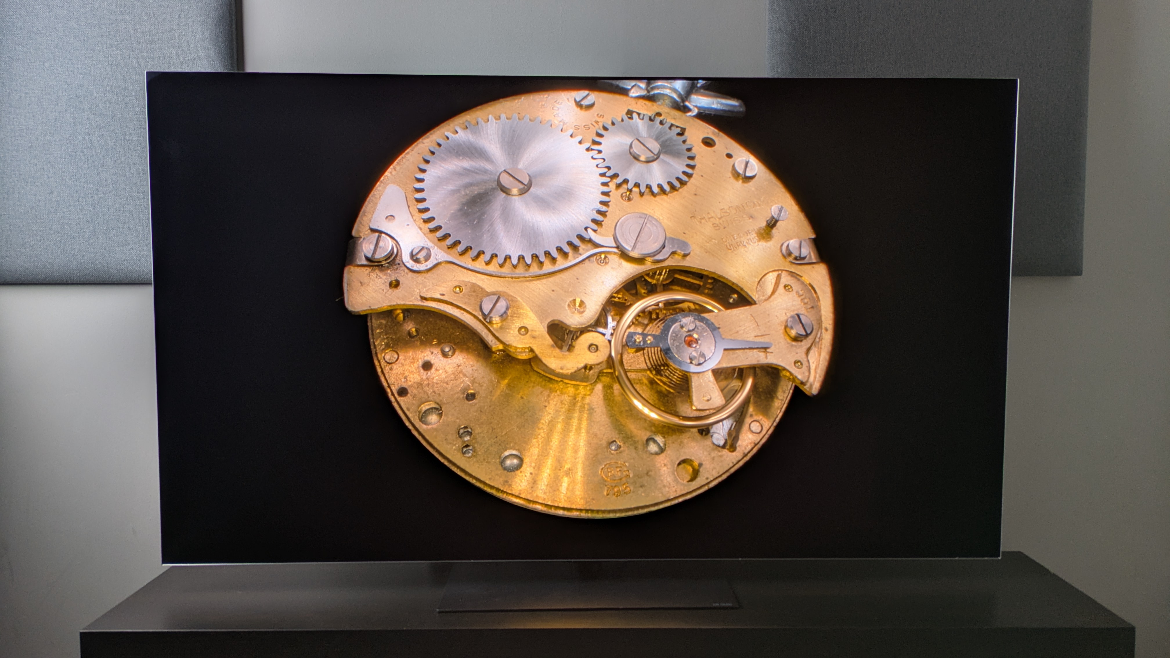 LG G6 OLED TV showing gold stopwatch on screen, exhibiting deep blacks and punchy, controlled highlights