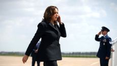 Vice President Kamala Harris talks on the phone outside Air Force One