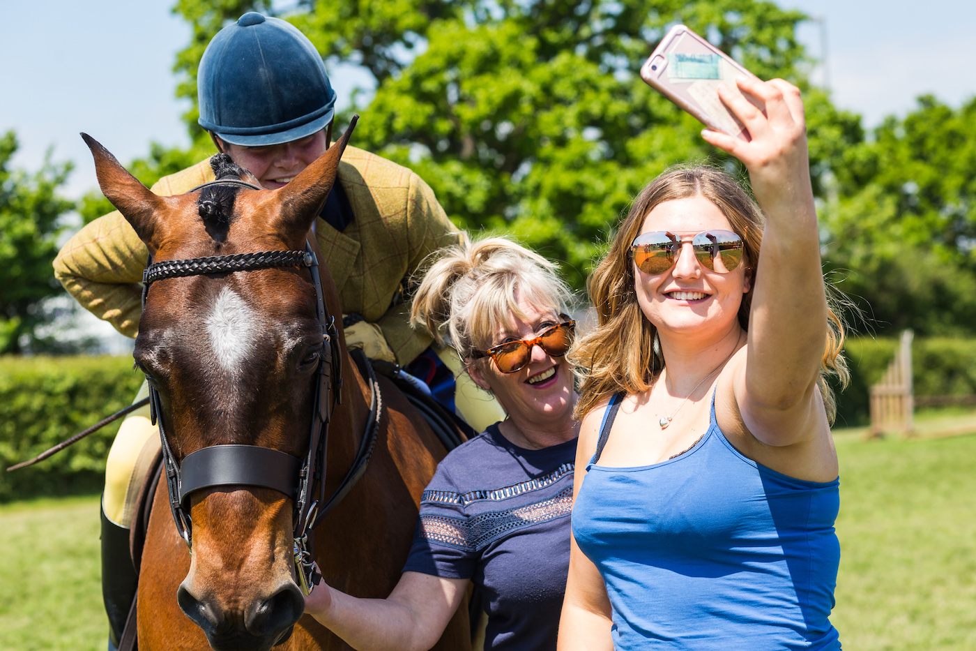 Happy showing rider with friends taking selfies