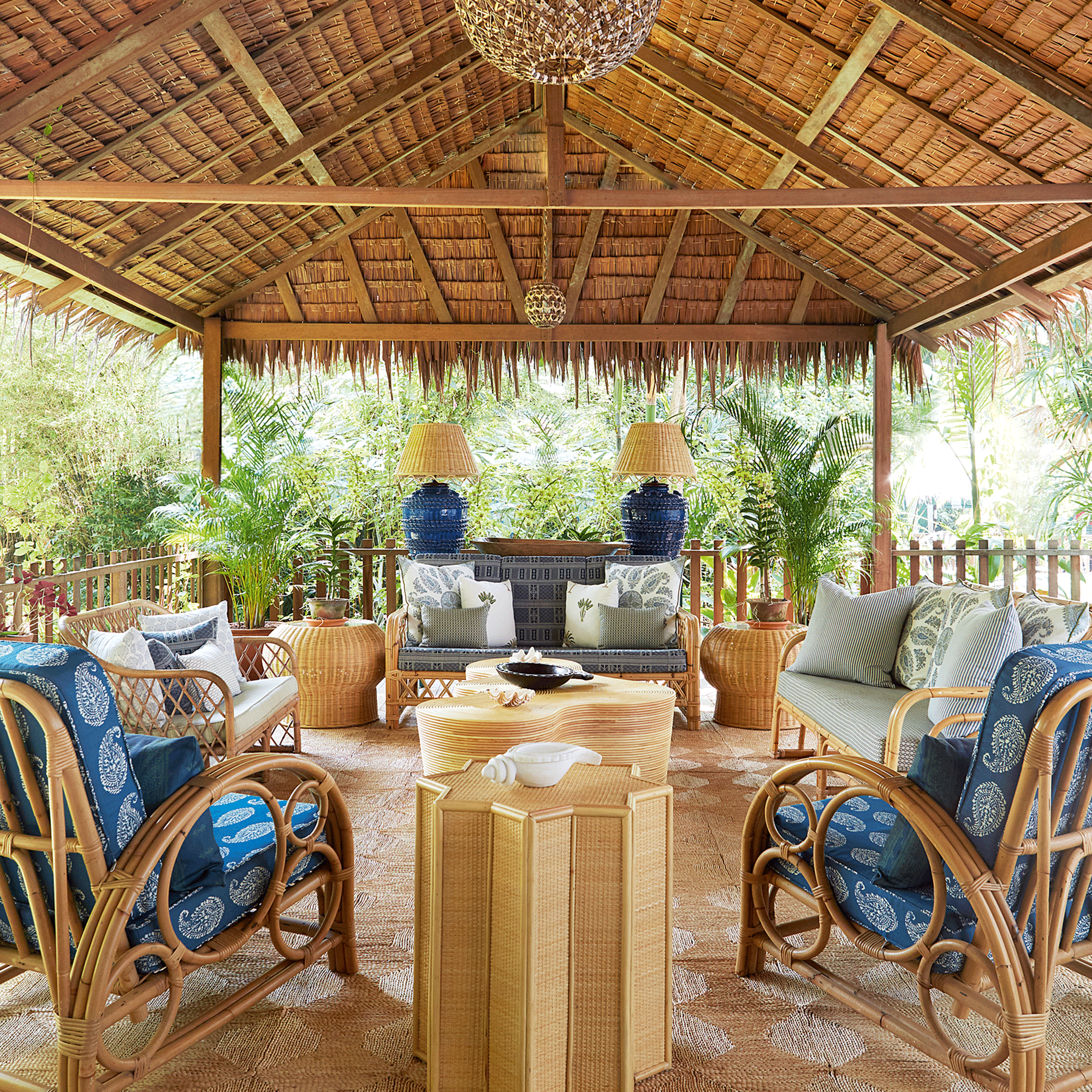 Straw roof garden room with rattan chairs