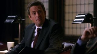 Matthew Perry looking to his right with a curious expression on The Good Wife.