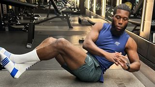 Lewis Paris demonstrates one position of the Russian twist exercise in a gym