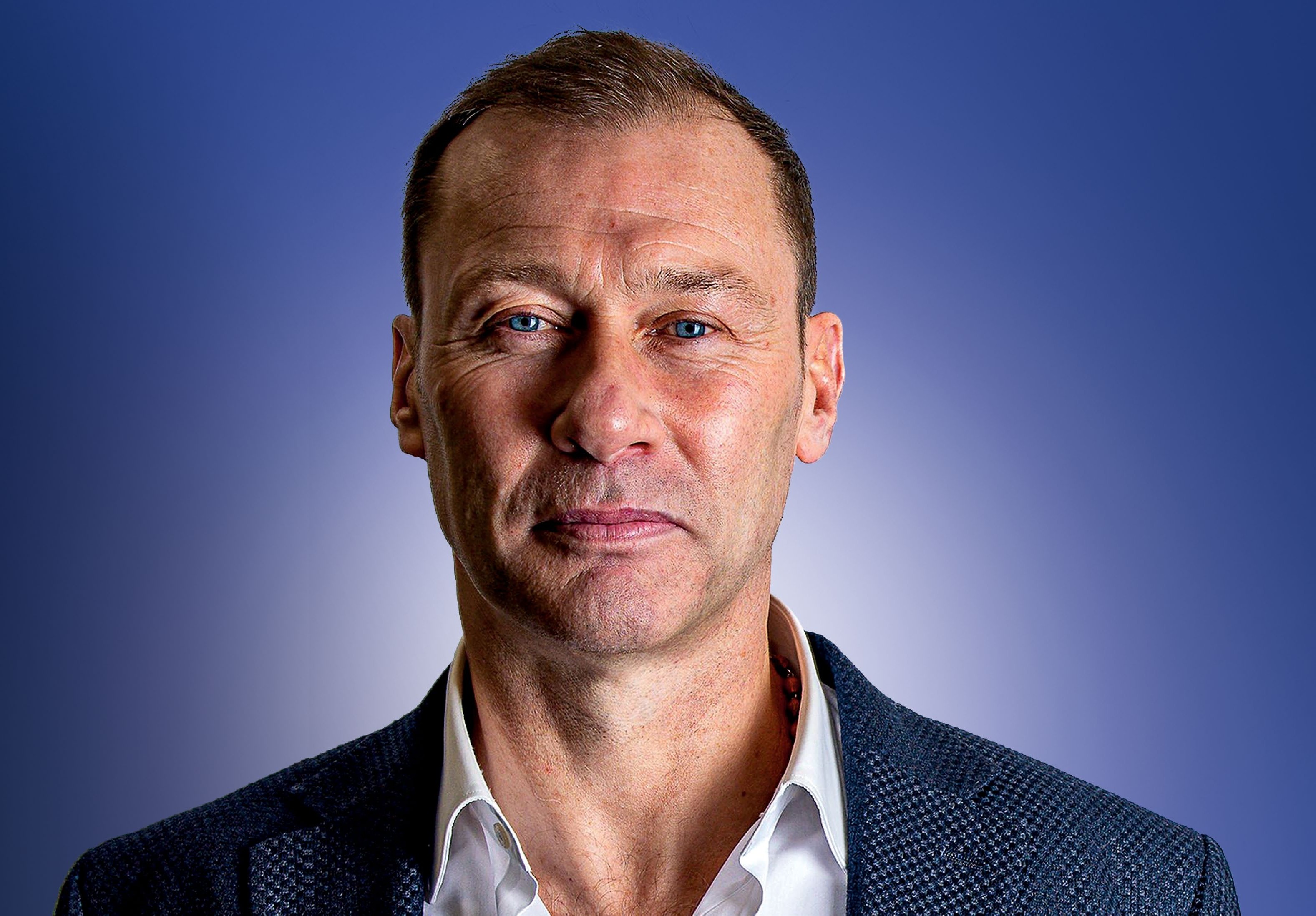 Portrait of Duncan Ferguson, a former professional footballer, against a blue background.