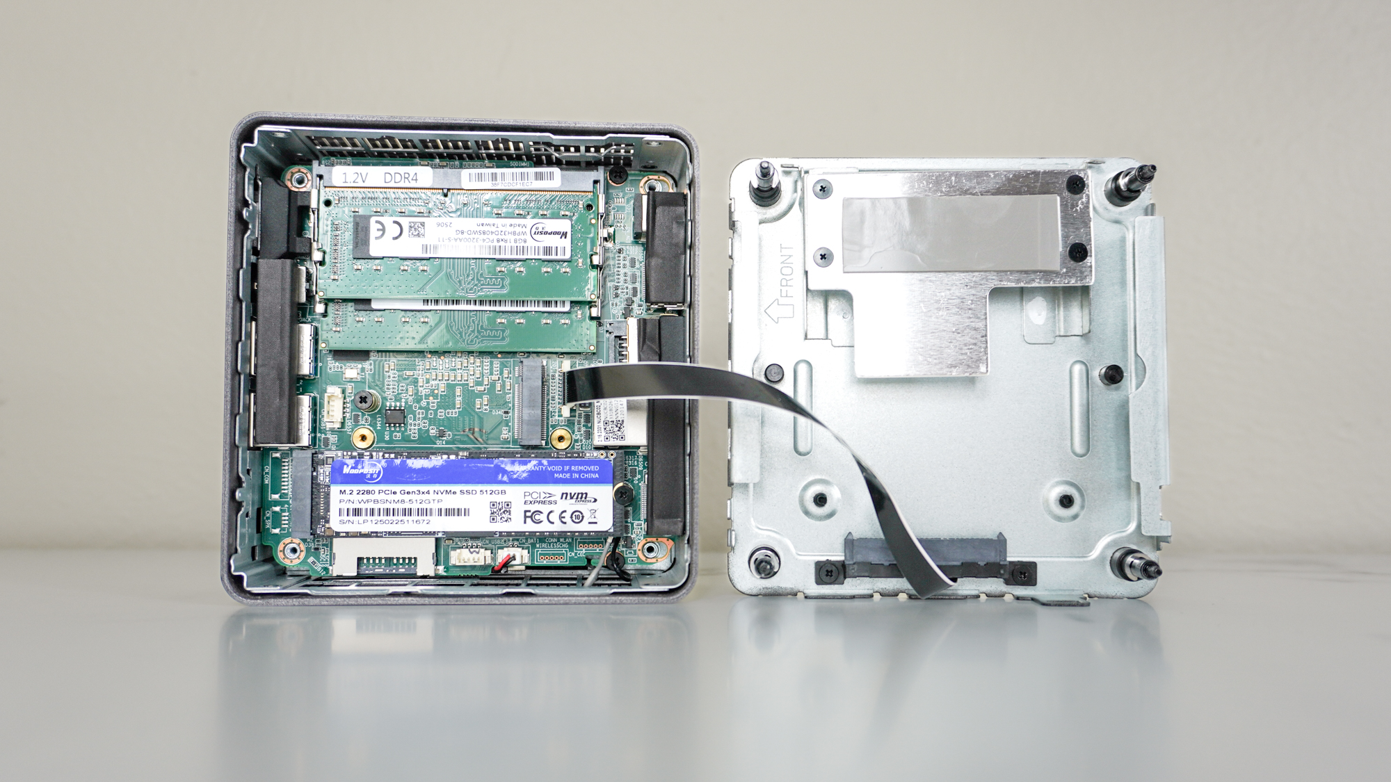 The Geekom A5 mini PC on a table with the case open showing off its internals