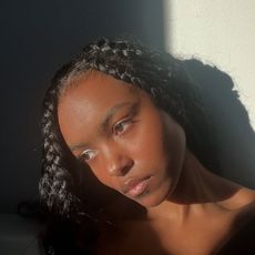 A selfie of Destiny Joseph posing in front of a stream of light.