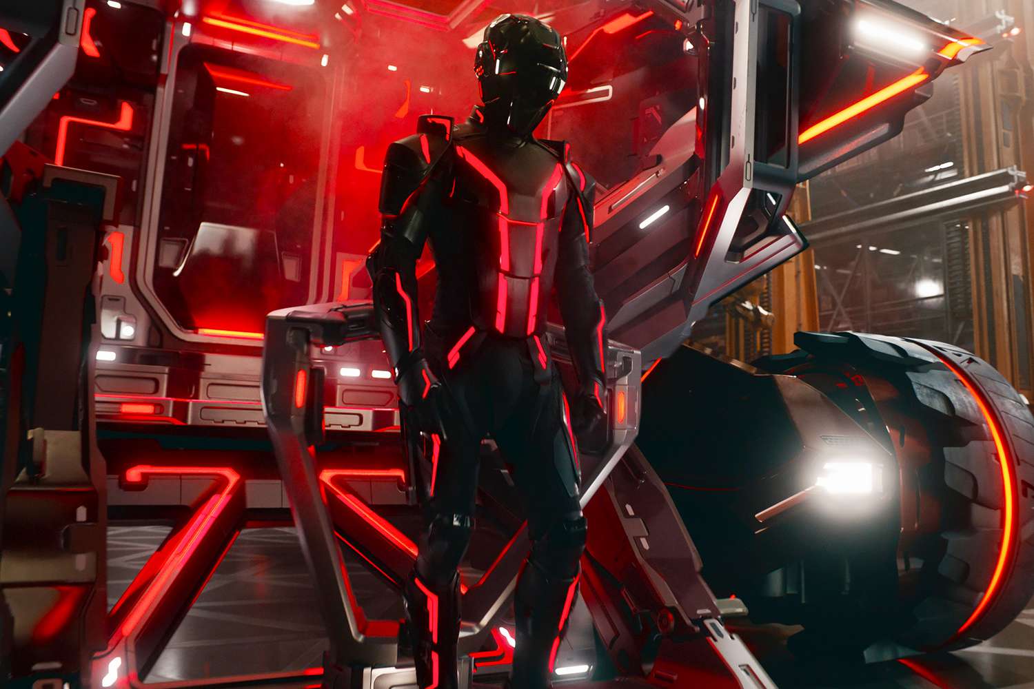 jared leto in a black and red suit emerging from a car in a still from tron ares