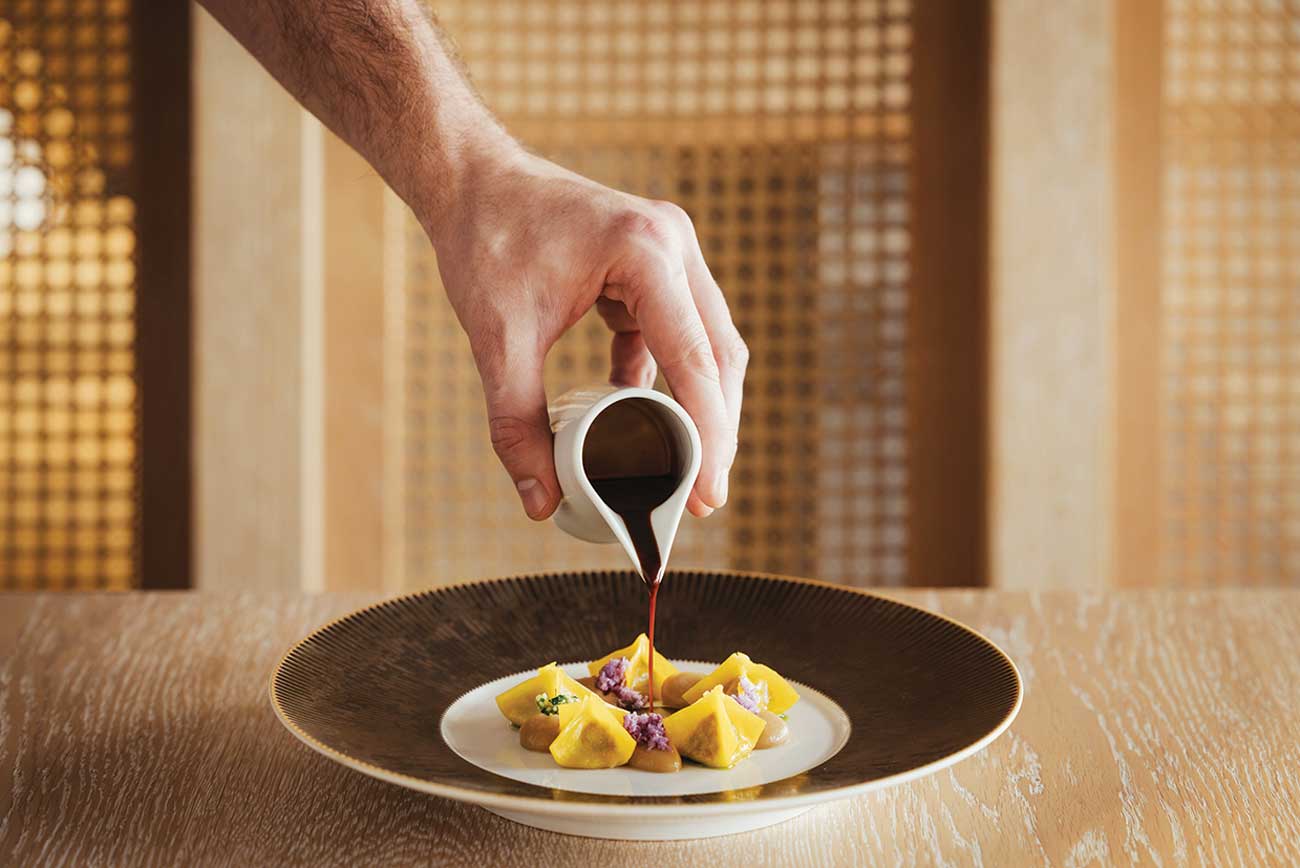 Pasta dish with sauce being poured over the top