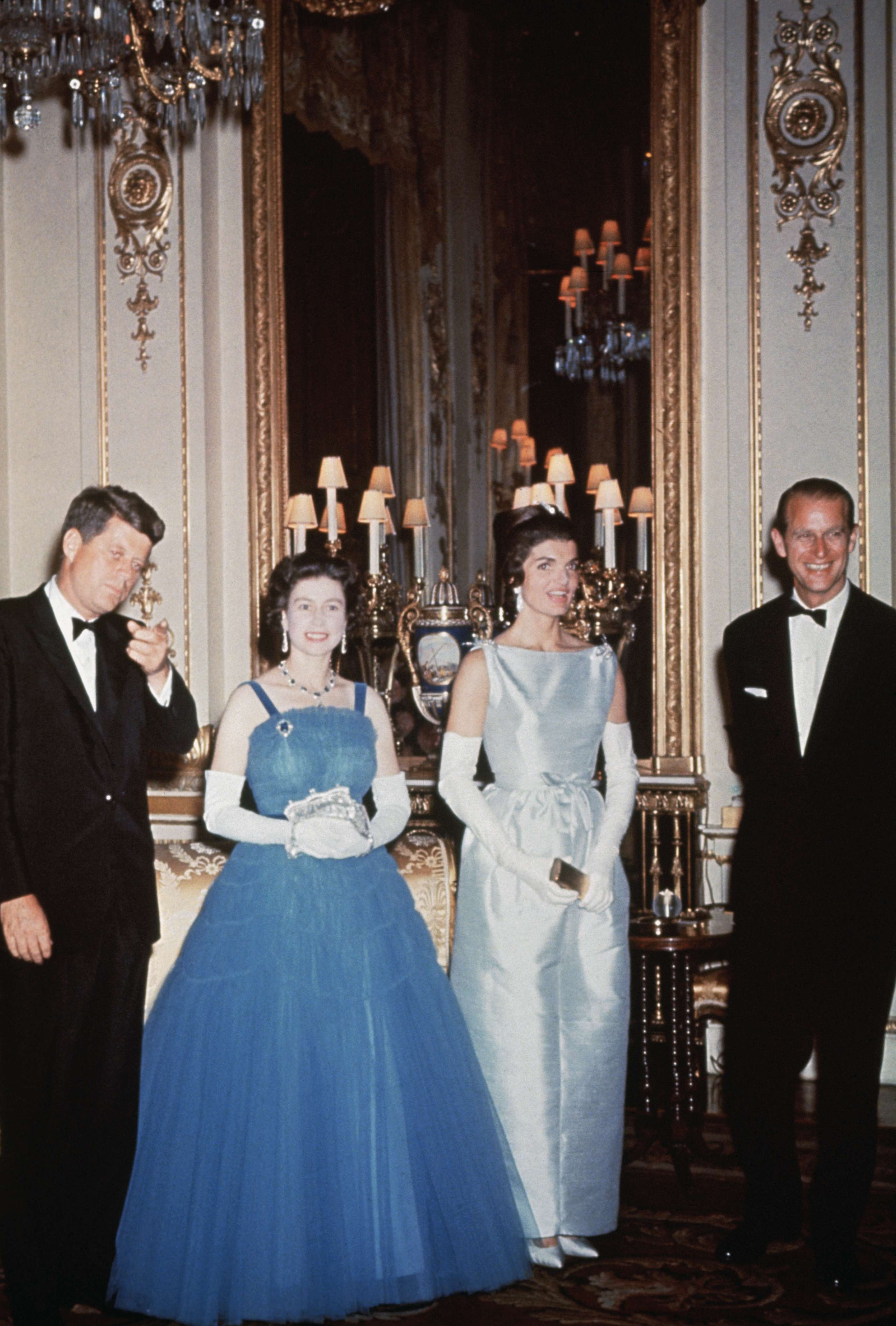 John F. Kennedy, Queen Elizabeth, Jackie Kennedy, Prince Philip wearing evening gowns and tuxes at Buckingham Palace and standing in a row