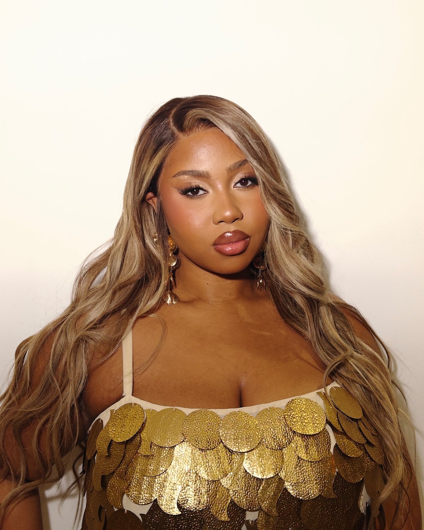 Lauren-Nicole with brown hair with blonde highlights and waves