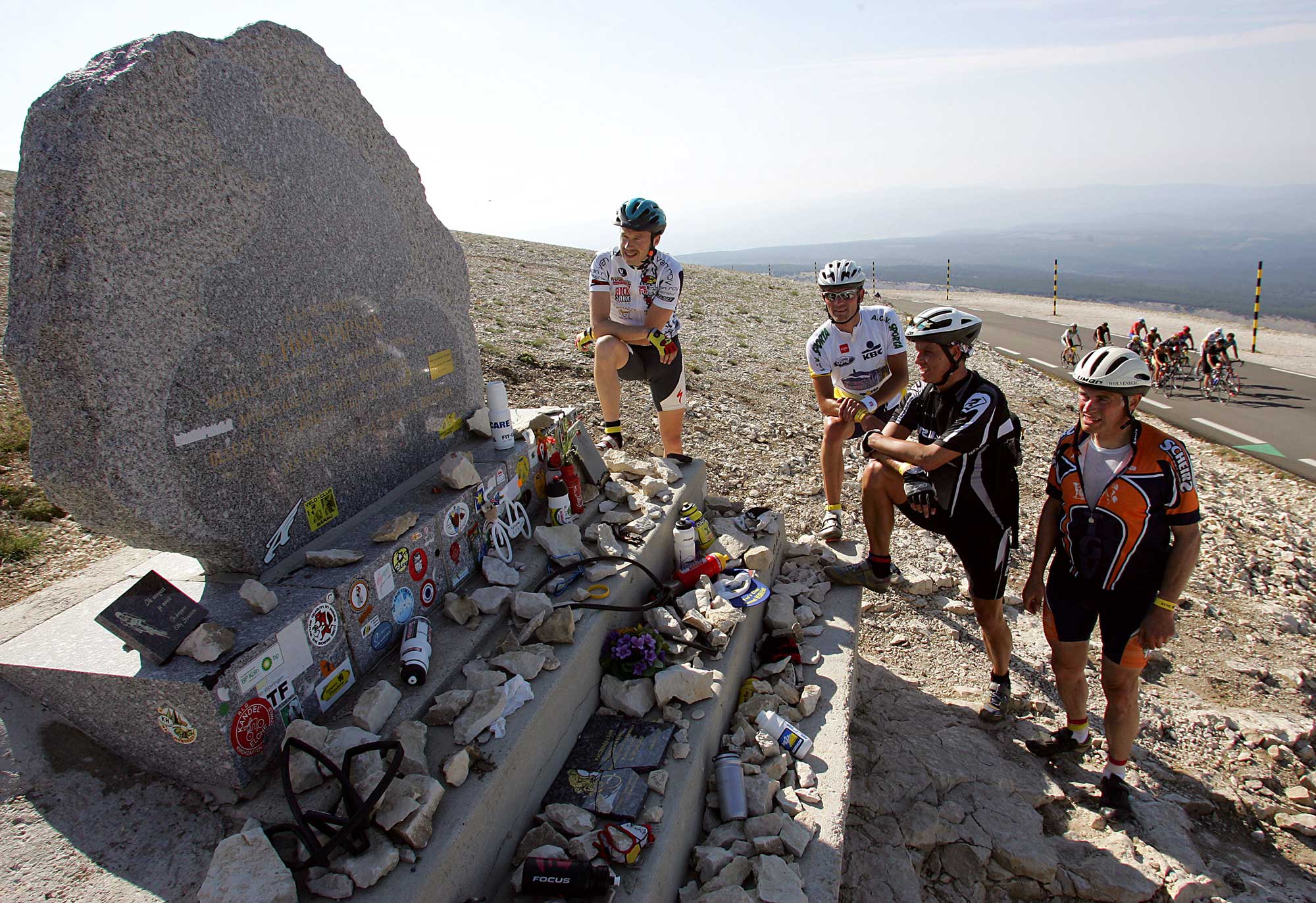 Competitors stand at the Tom Simpson Memorial 18 June 2005 at the Mont Ventoux during a gathering of some 1200 amateur Belgian cyclists AFP PHOTO BORIS HORVAT Photo credit should read BORIS HORVATAFP via Getty Images