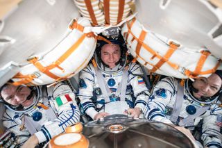 Expedition 53 crewmembers Randy Bresnik of NASA (right), Paolo Nespoli of the European Space Agency (center) and Sergey Ryazanskiy of Russia's Roscosmos agency are seen inside their Soyuz MS-05 space capsule wearing Sokol spacesuits as they prepare to return to Earth on Dec. 14, 2017.