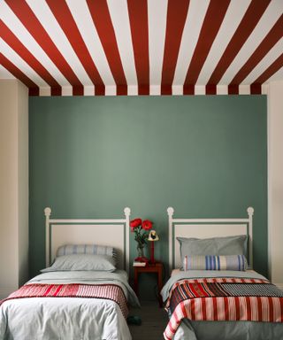 Stripy red and white ceiling with green walls in bedroom