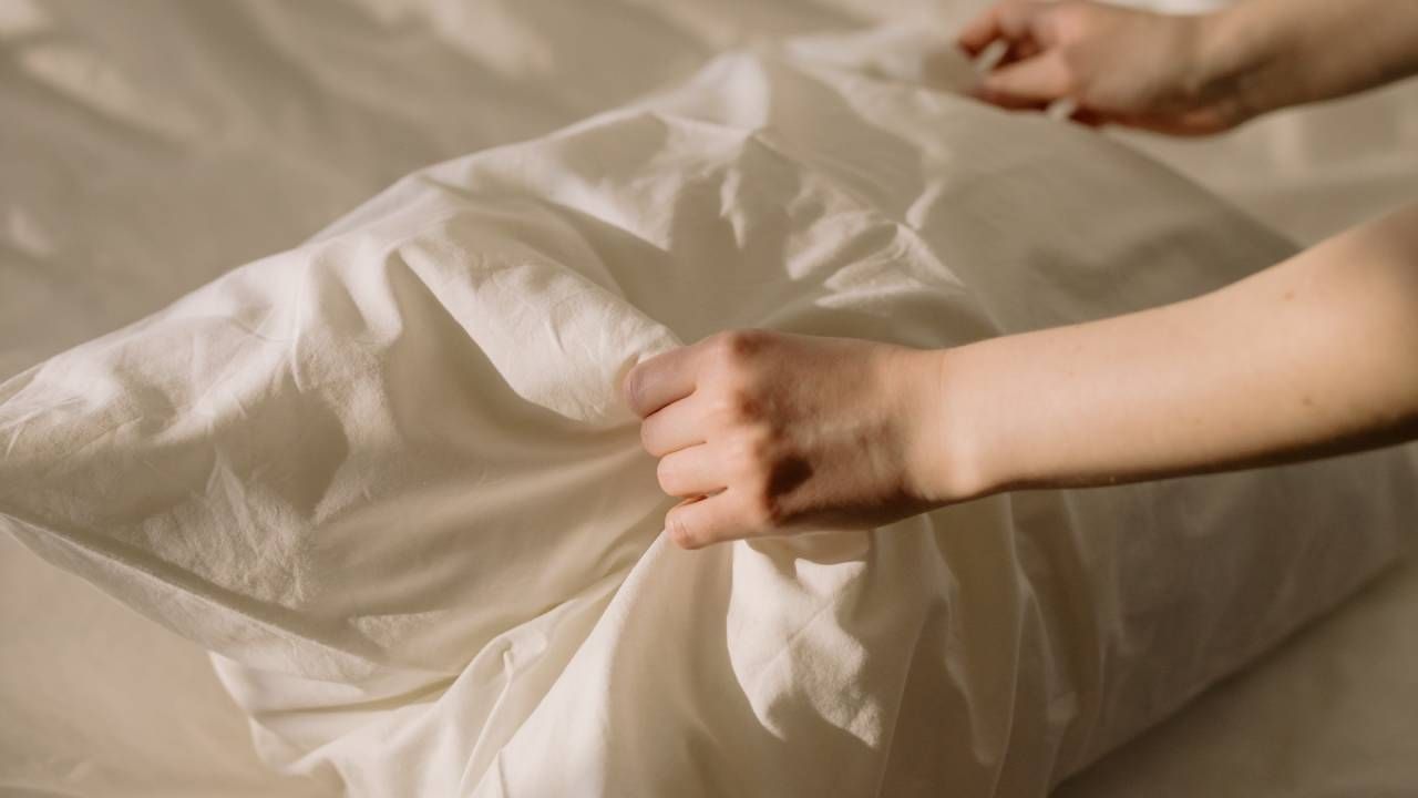 Person holding a pillow, cleaning tips