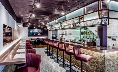 Seating at the bar with red barstools