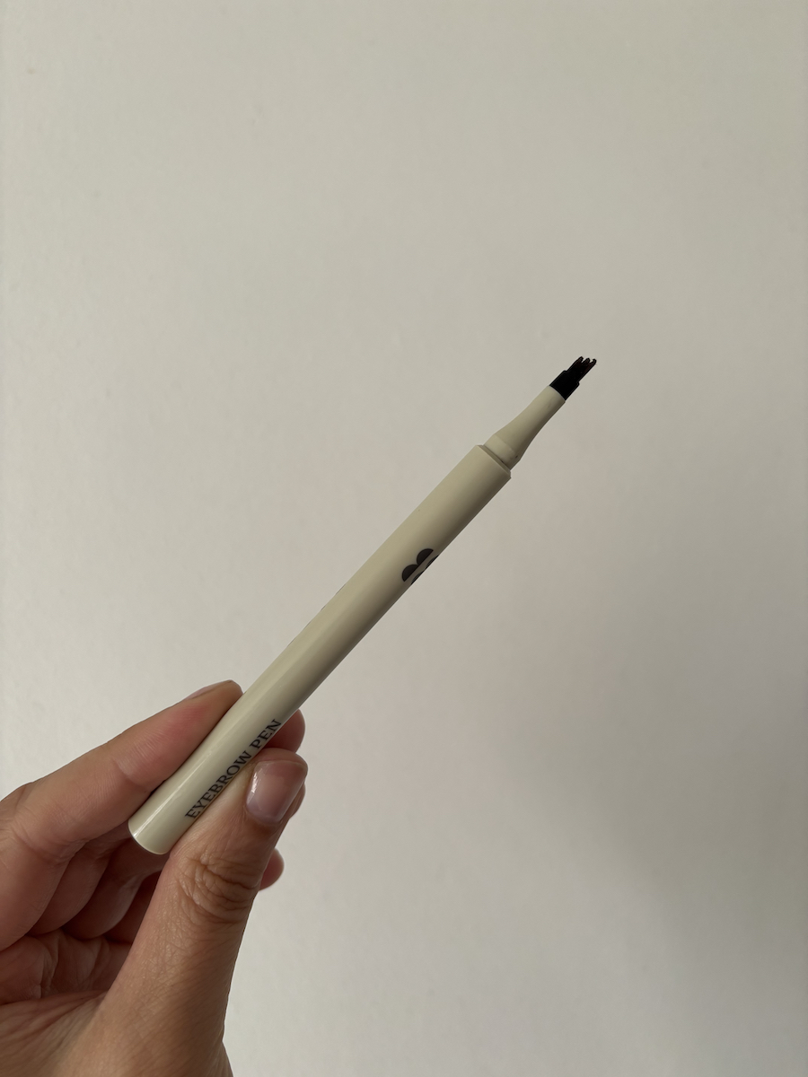 Mica Ricketts holding Blink Brow Pen