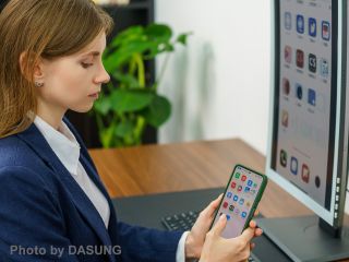 Dasung Paperlike Colour E-ink monitor used by woman in a navy blazer at a desk