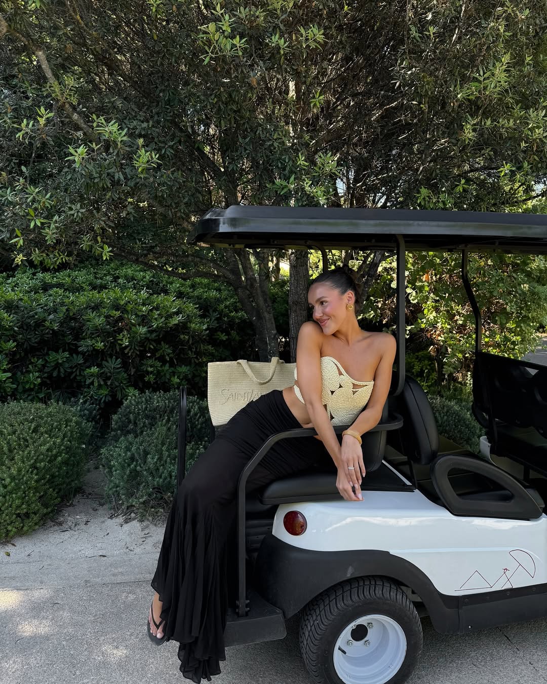 Emma Leger in Saint-Tropez with tan skin and a slicked-back bun