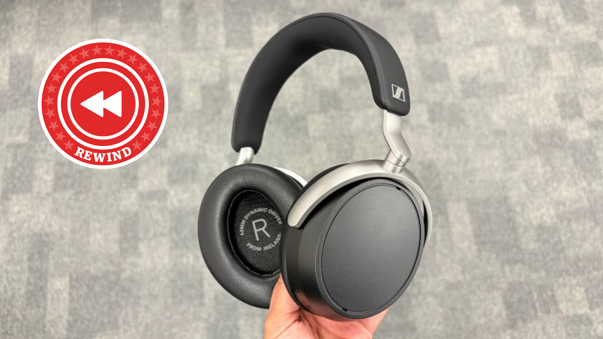 Wireless headphones being held next to Rewind logo