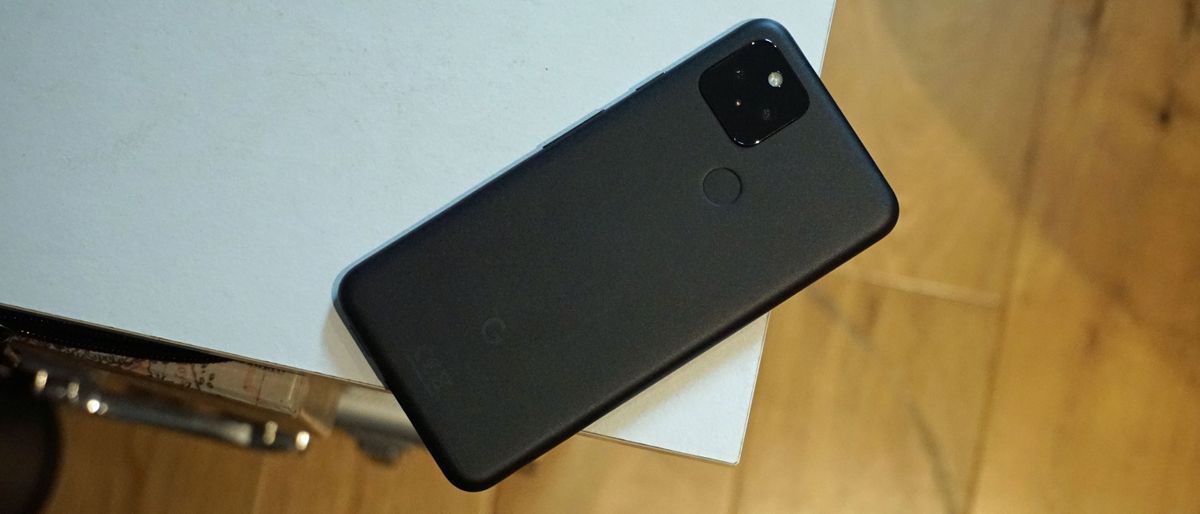 A Google Pixel 5 from the back, on the edge of a table