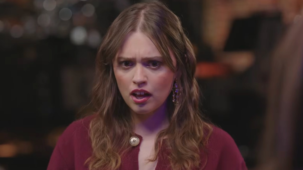 Aimee Lou Wood reacting to the cast all having moustaches. 