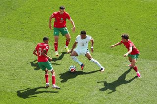 FOXBOROUGH, MASSACHUSETTS - JULY 09: Kylian Mbappe #10 of France controls the ball against Azzedine Ounahi #8, Bilal El Khannouss #23 and Neil El Aynaoui #24 of Morocco during the FIFA World Cup 2026 Quarter Final match between France and Morocco at Boston Stadium on July 09, 2026 in Foxborough, Massachusetts. (Photo by Julian Finney - FIFA/FIFA via Getty Images)
