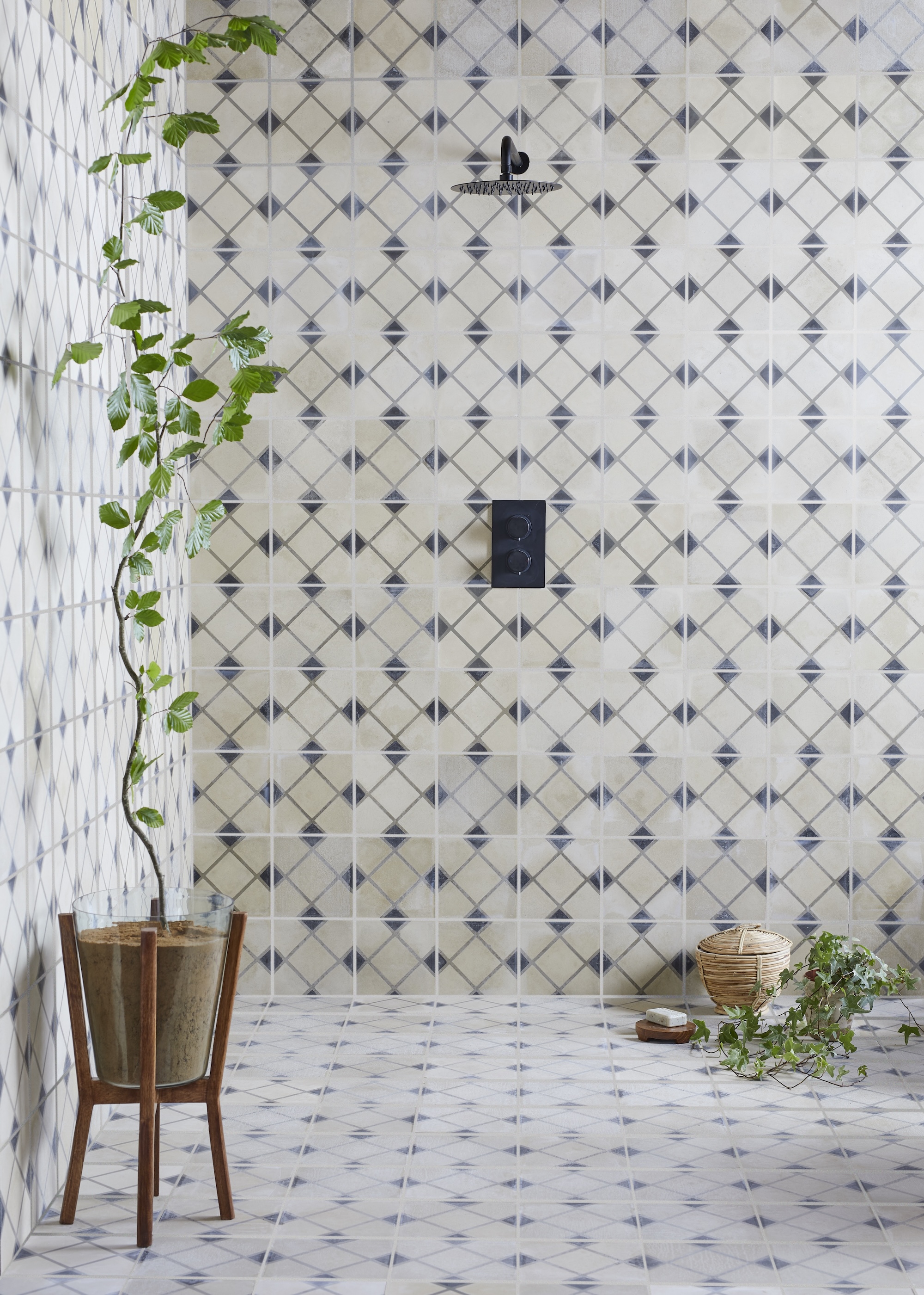 A tile drenched bathroom with plants scattered around