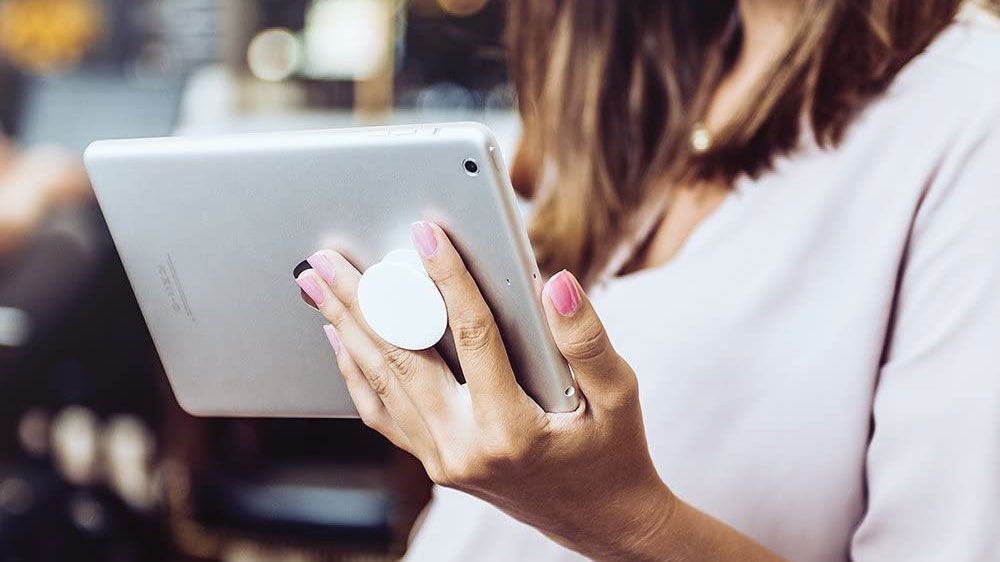 Best PopSockets: lady holding a tablet with a popsocket on the back