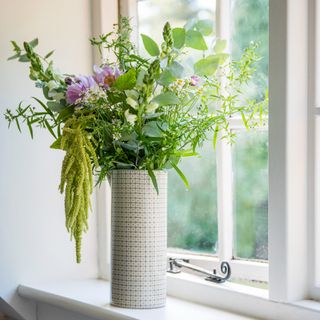 A vase of fresh flowers on a windowsill