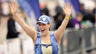 Woman wearing a running vest and sunglasses