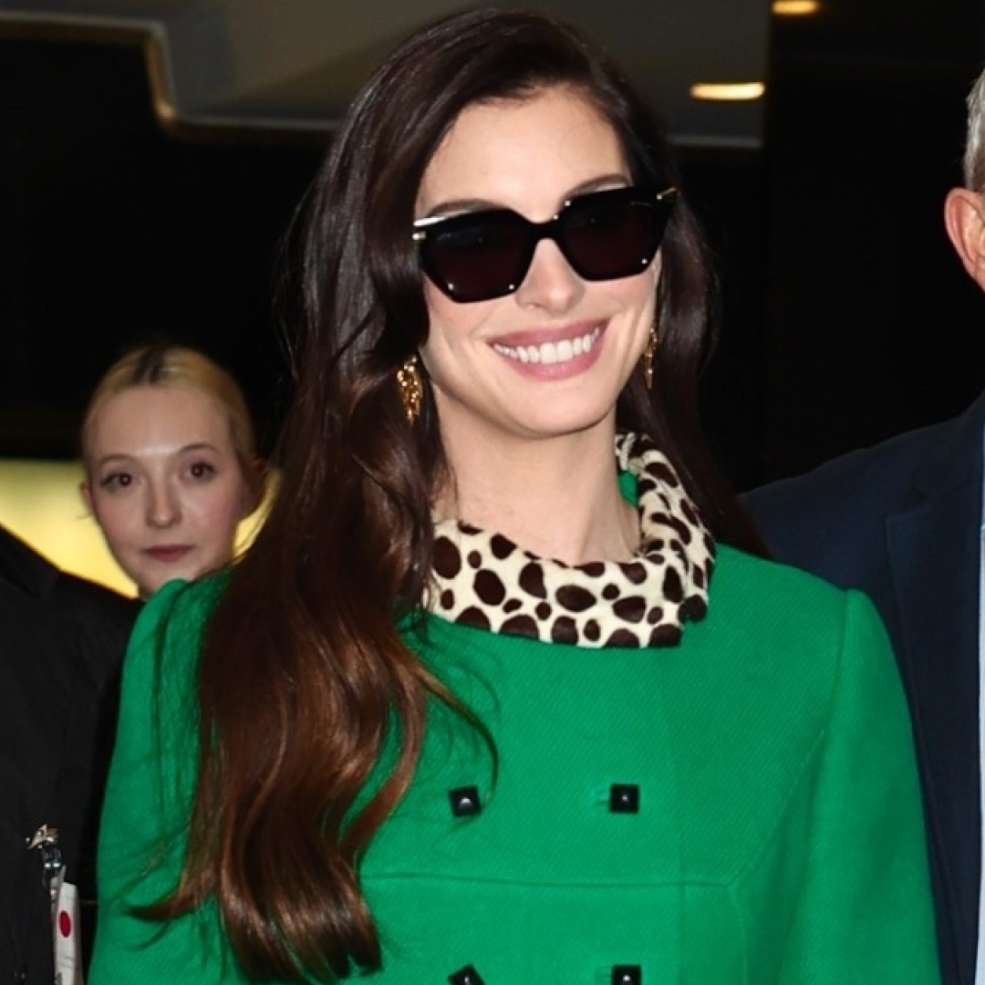 Anne Hathaway wore the green coat with leopard-print trim from the Devil Wears Prada on the Devil Wears Prada 2 press tour