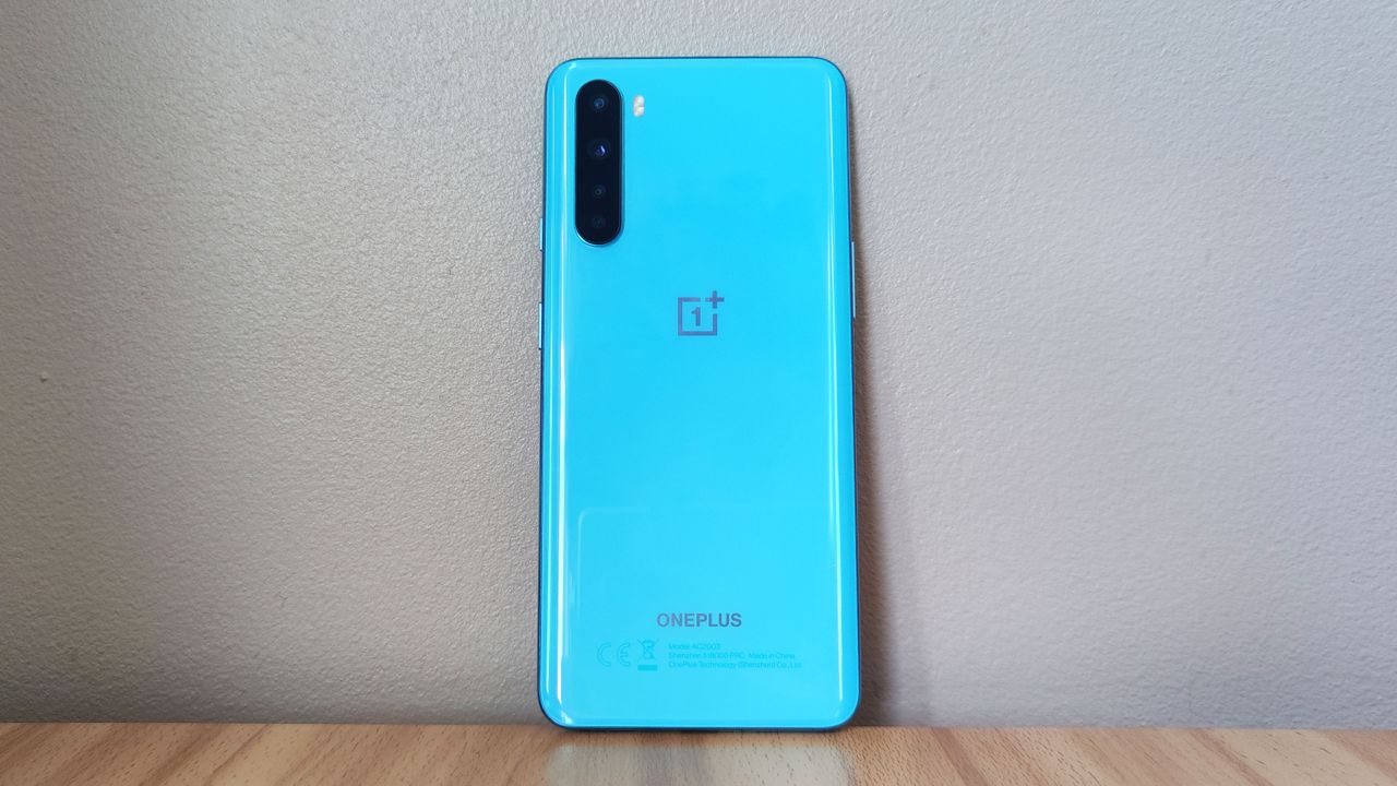 A OnePlus Nord in blue, resting against a wall