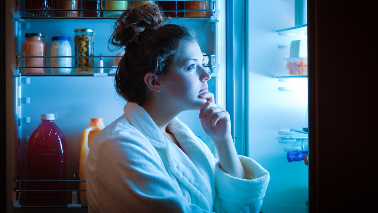 woman looking in fridge