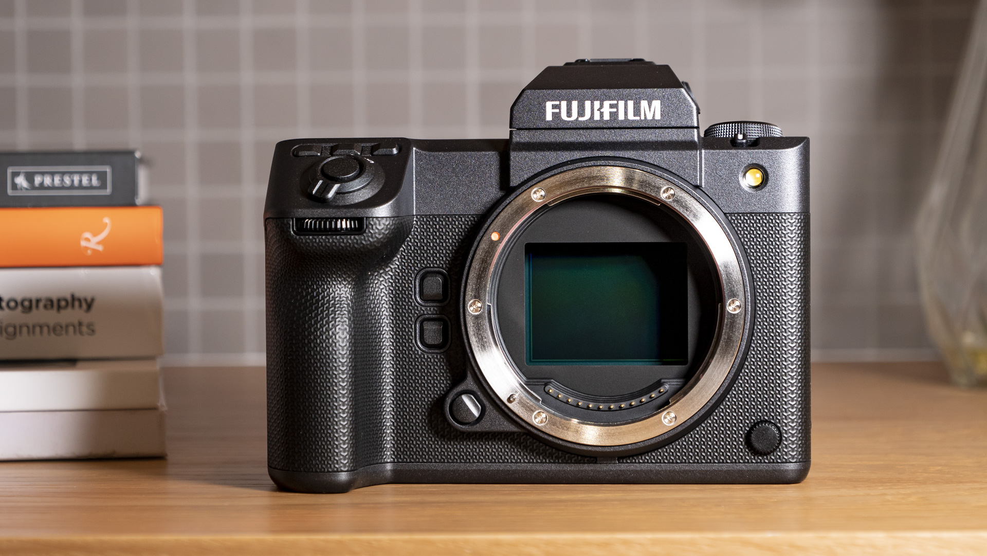 Fujifilm GFX100 II on wooden table with no lens attached