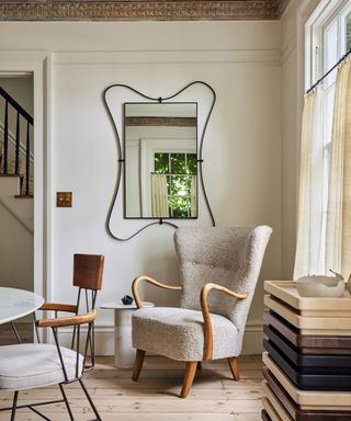 Grey armchair, mirror with black frame