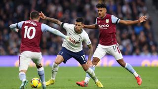 Cristian Romero of Tottenham Hotspur is challenged by Emi Buendia and Ollie Watkins of Aston Villa