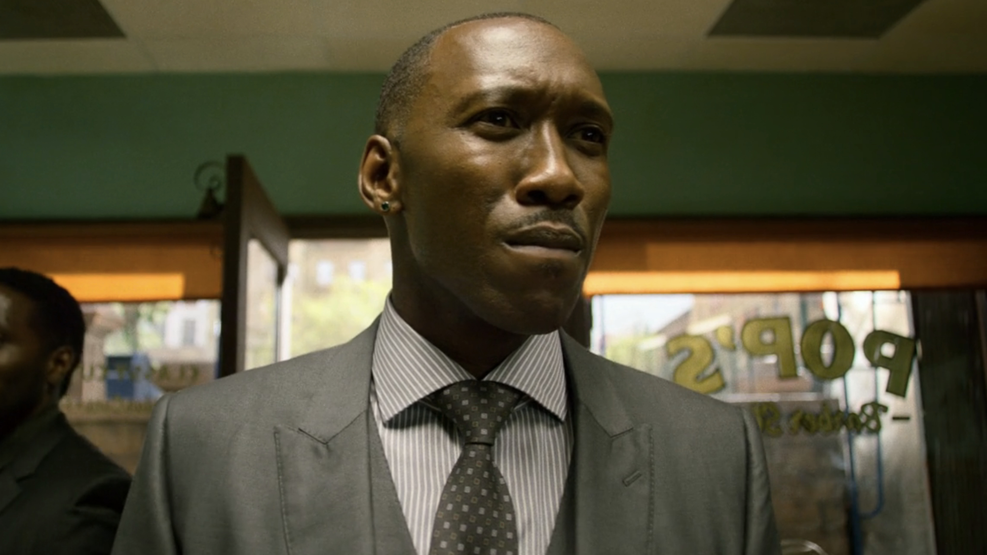 Cornell Stokes (Maheshala Ali) enters the barbershop on Luke Cage.