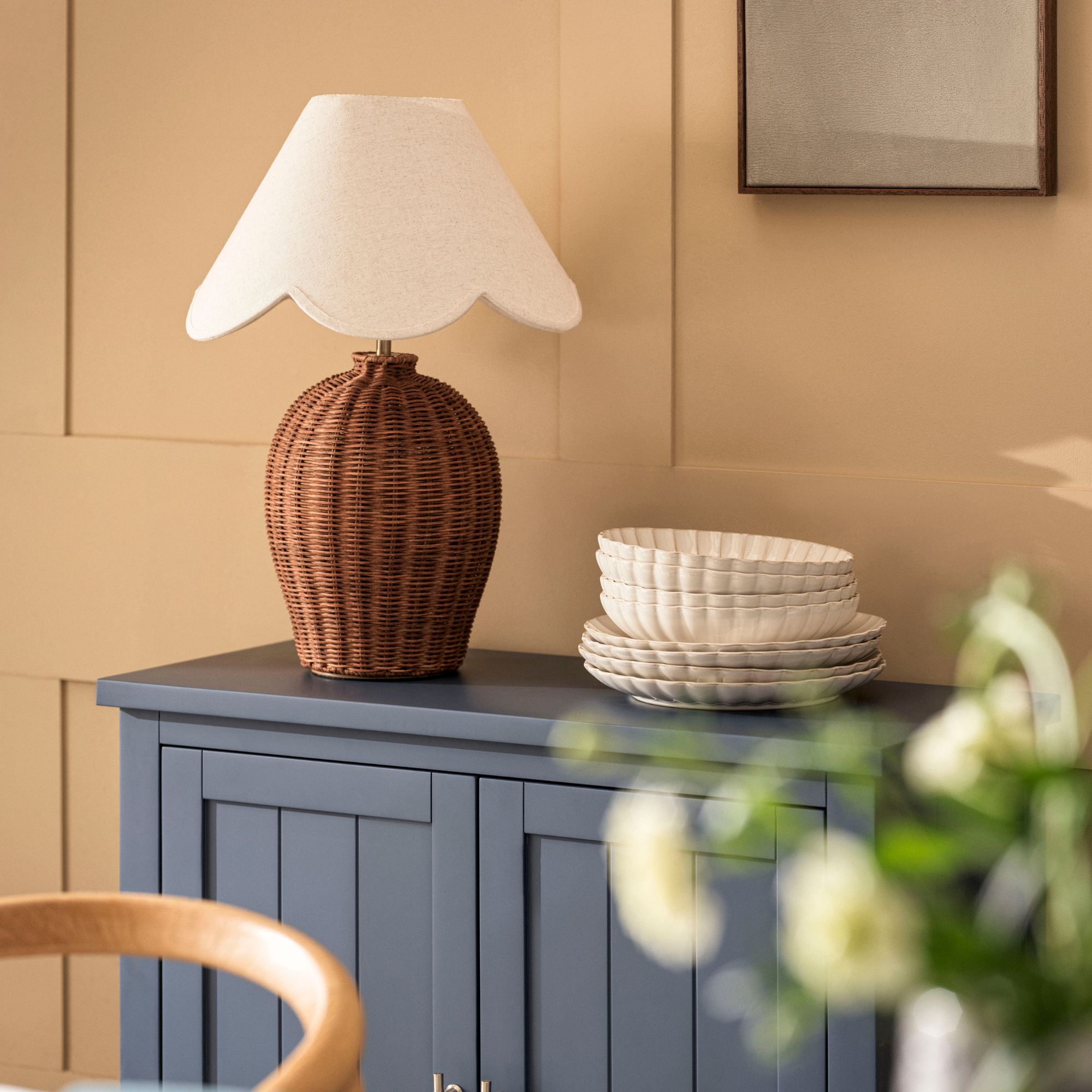 M&amp;S scalloped wicker table lamp on a blue sideboard.