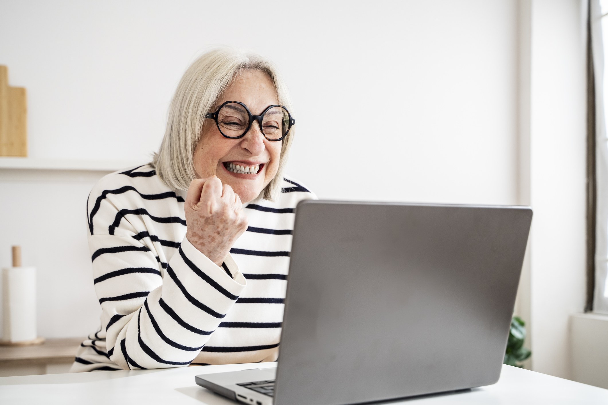 A woman happy as she reviews her personal finances