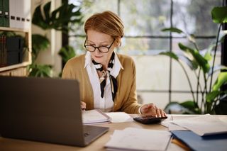 Woman doing taxes online in a home office