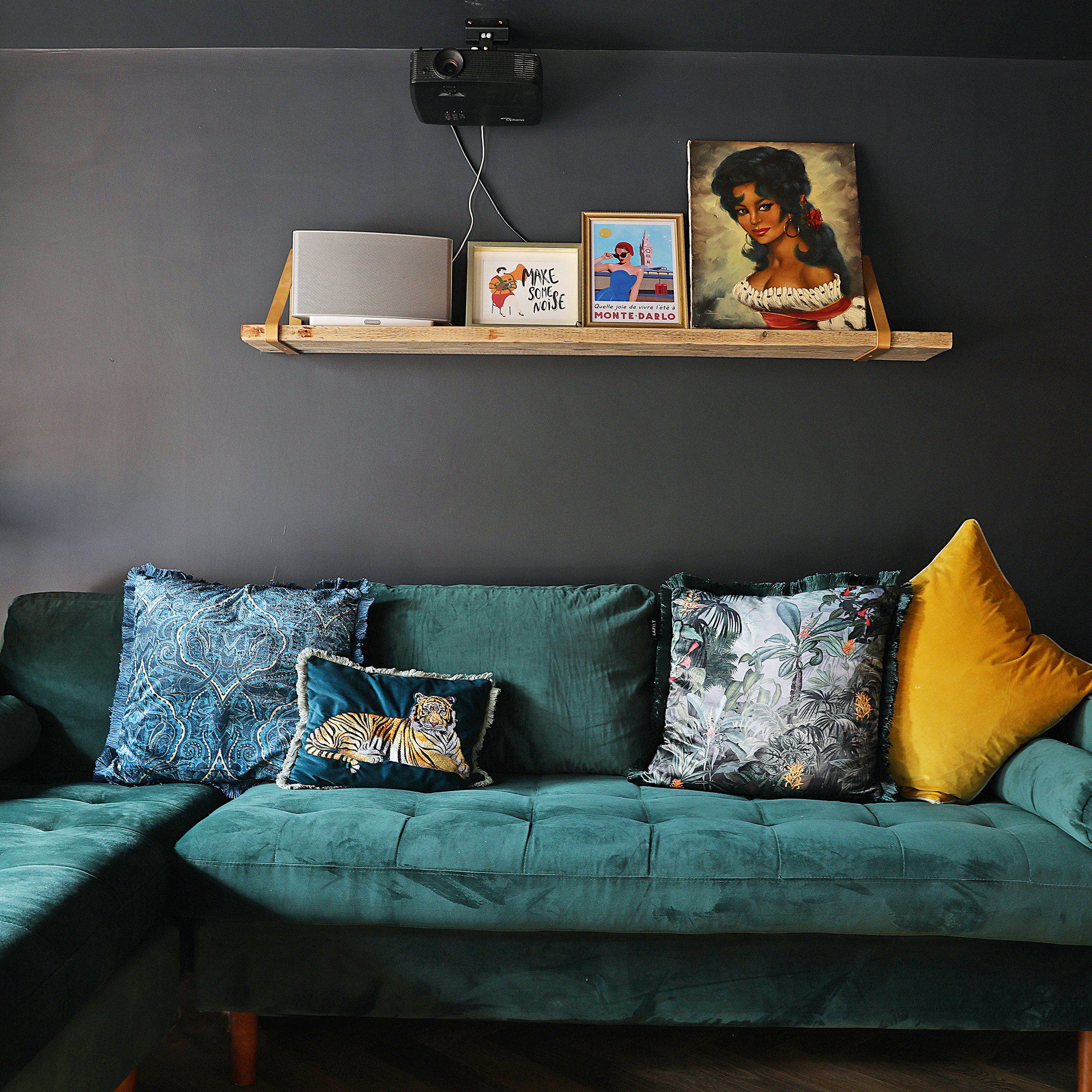 Victorian property revamp basement with dark moody walls and green velvet sofa