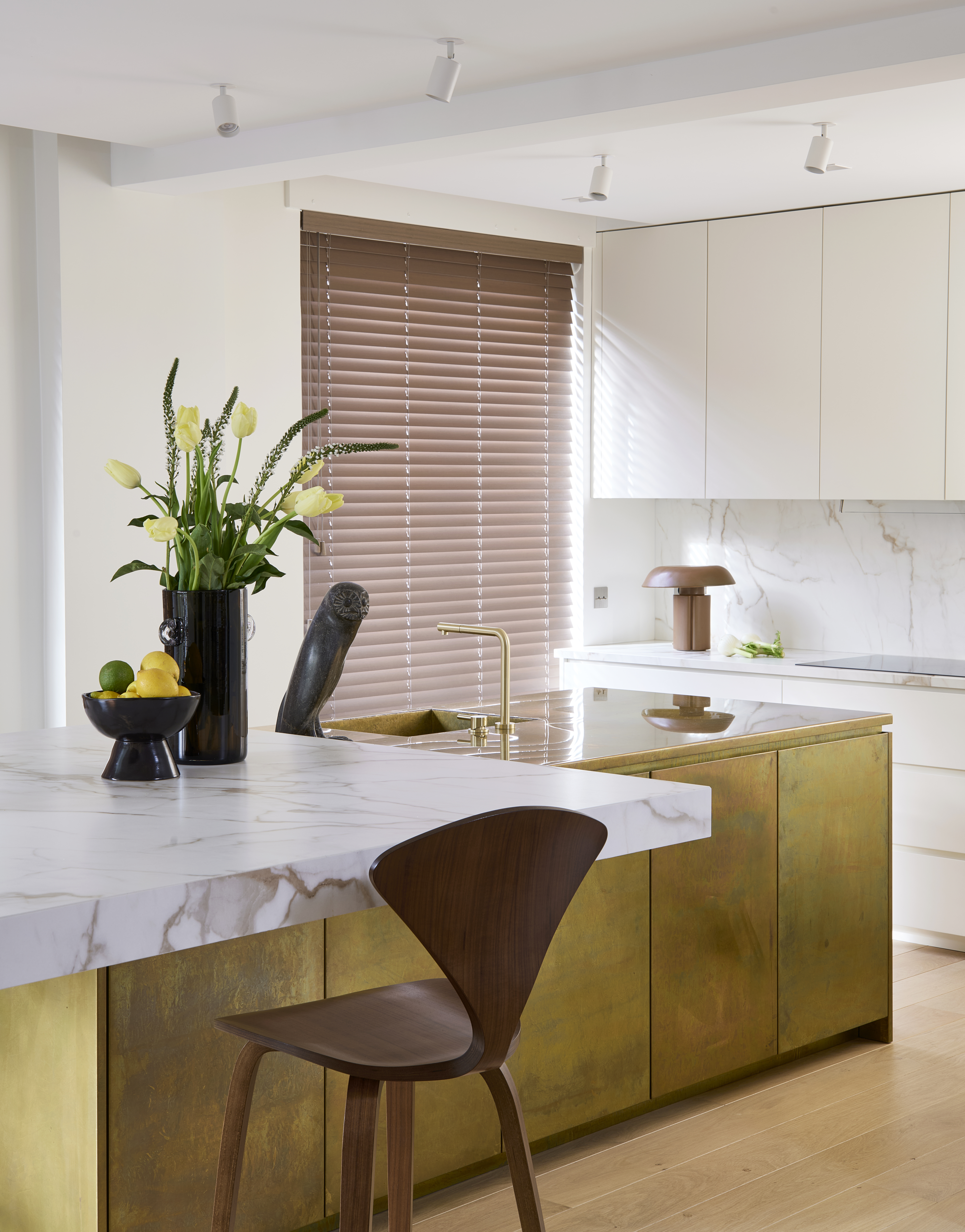 A kitchen with a brass island