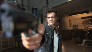 Jack Quaid pointing a gun in Novocaine