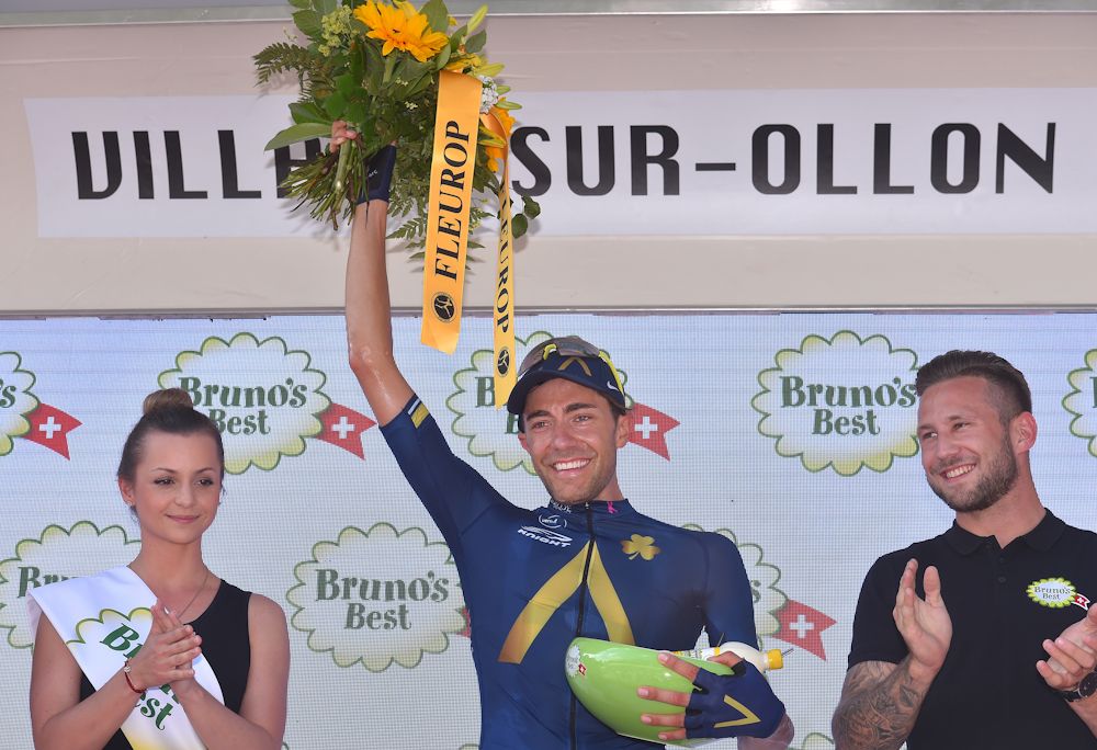 Larry Warbasse on the podium after winning stage 4 at the Tour de Suisse