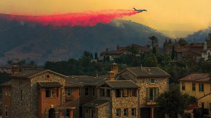 firefighting plane flying over house